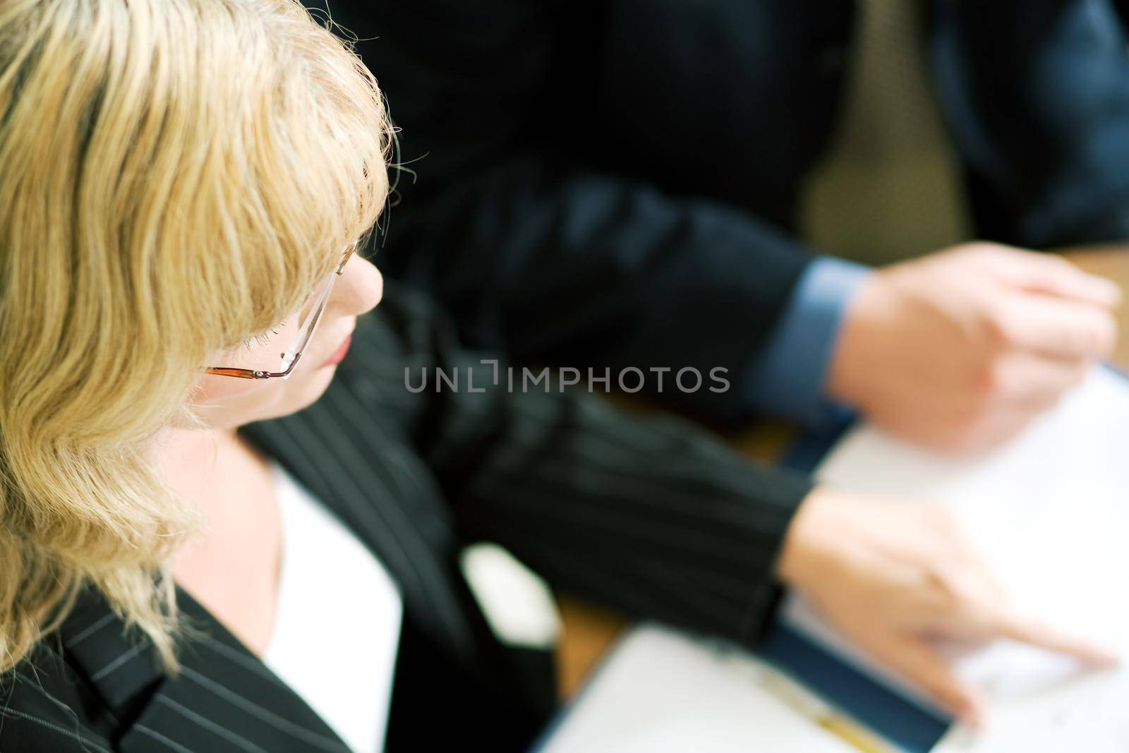 A portrait of a female professional in a business meeting (very shallow depth of field)