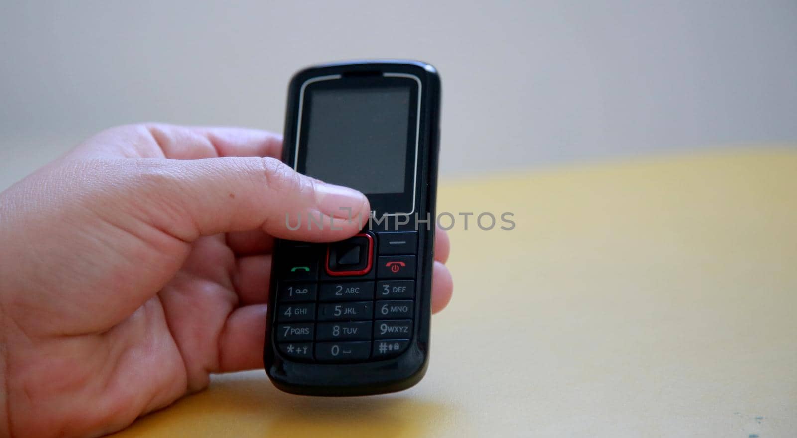 salvador, bahia / brazil - july 10, 2020: hand holds analog cell phone in the city of Salvador.