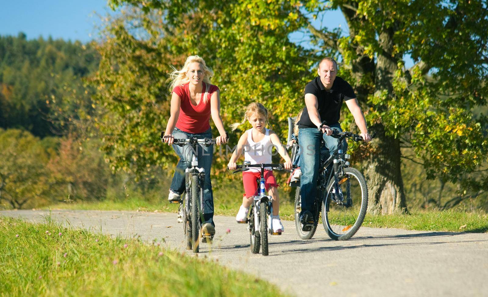 A family with children having a weekend excursion on their bikes