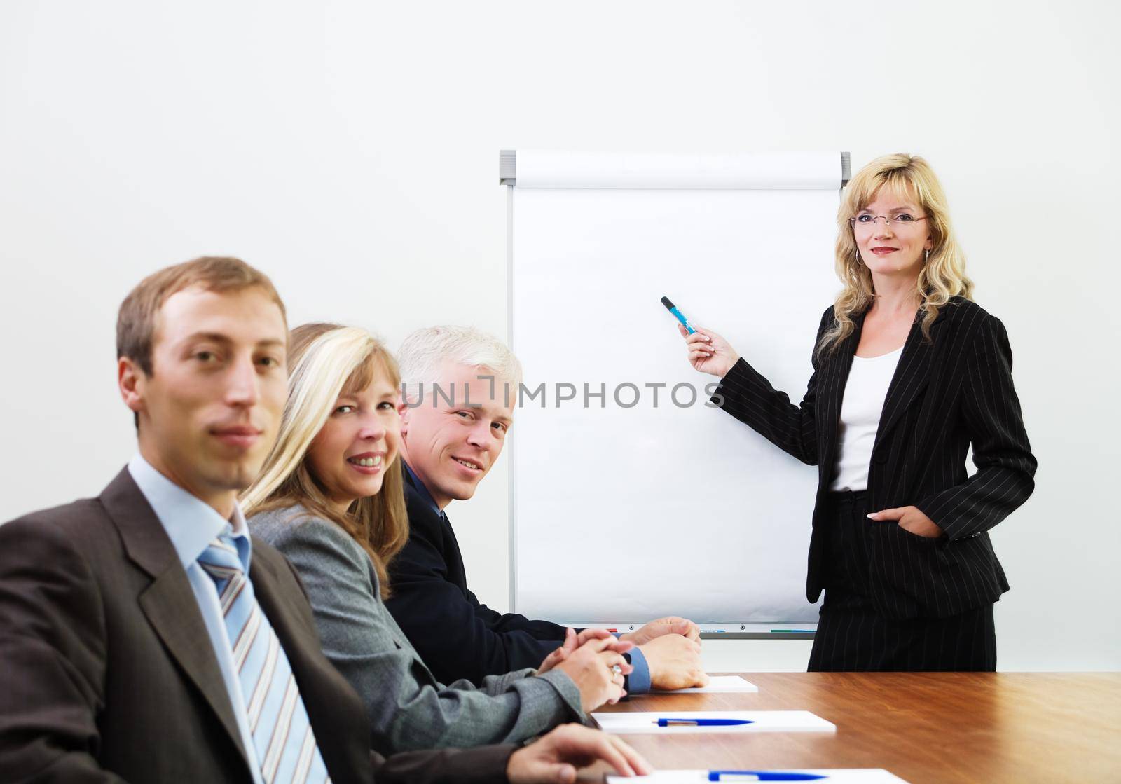 Businessteam in a presentation, looking at the viewer (focus on lecturer)