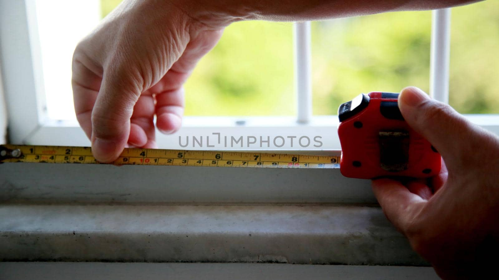salvador, bahia / brazil - july 10, 2020: hand holds measuring tape with measuring scale in the city of salvador.