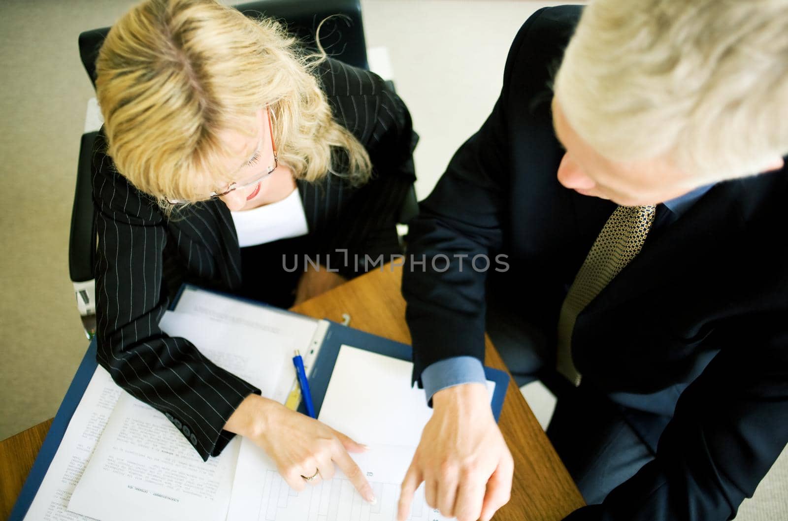 Two Executives discussing documents (very shallow depth of field)