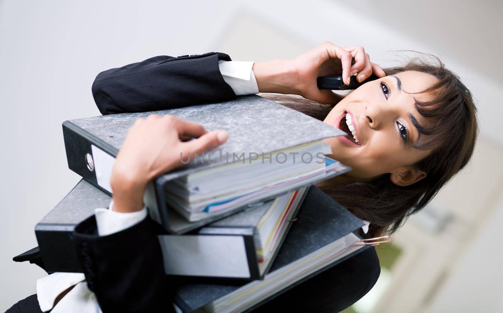 An office woman handling simultaneous jobs rather successful