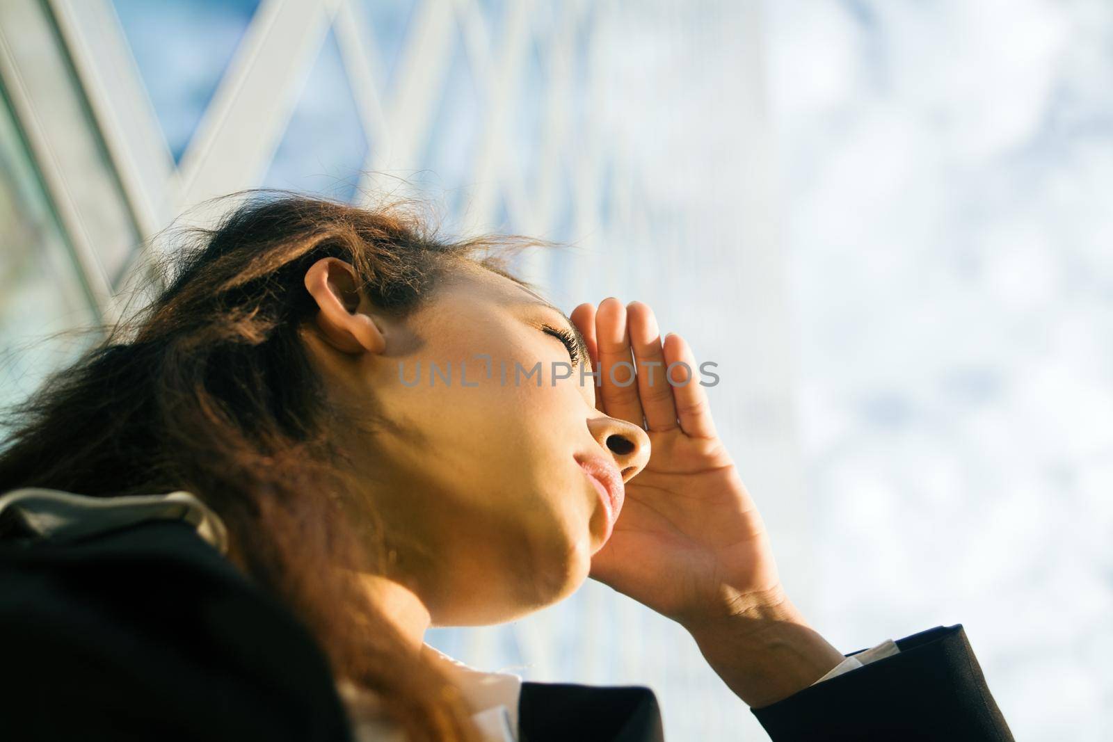 Young woman looking at front of an office building