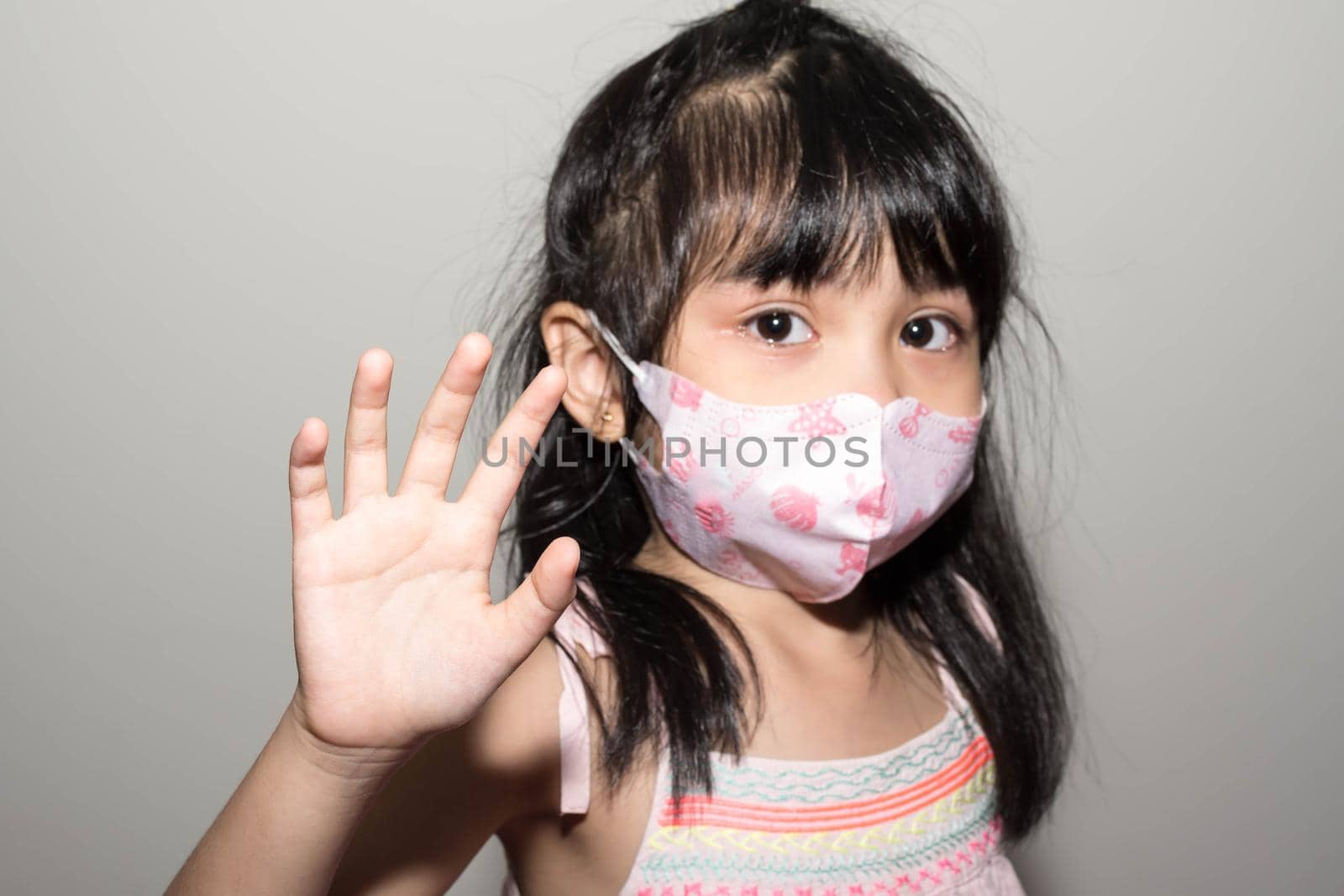 Kids hand to say no against corona virus infection. Blurry image of a female kid showing her hand to symbolize against the spread of corona virus