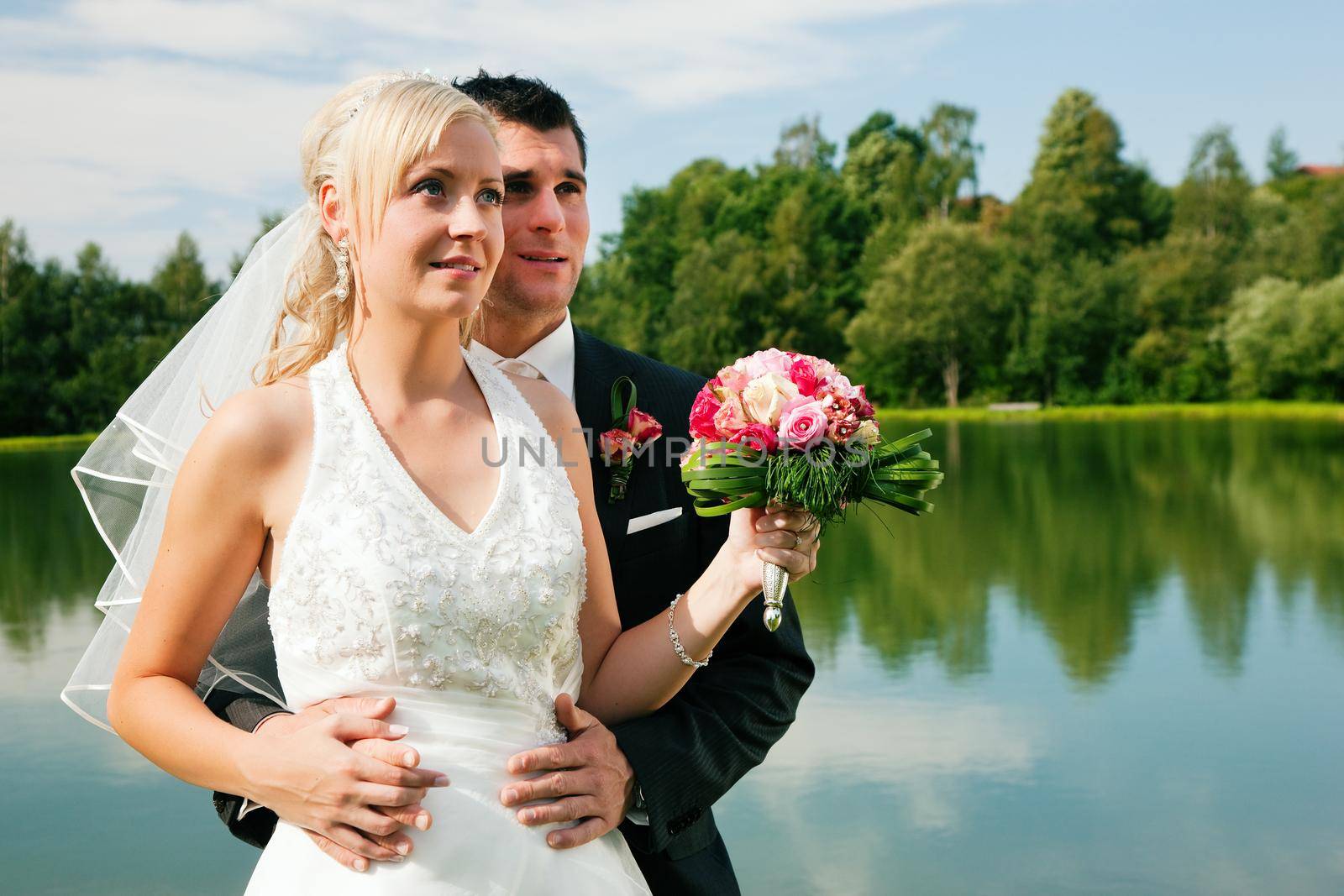 Wedding couple looking into future by Kzenon