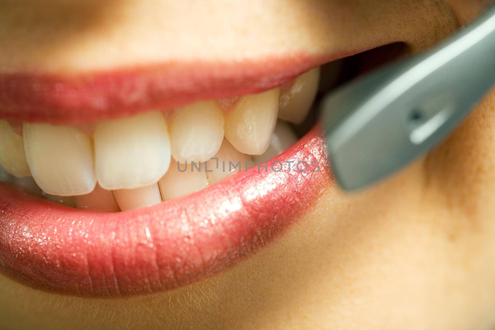 Close-up (mouth) of a friendly female call center operator; very shallow depth of field!