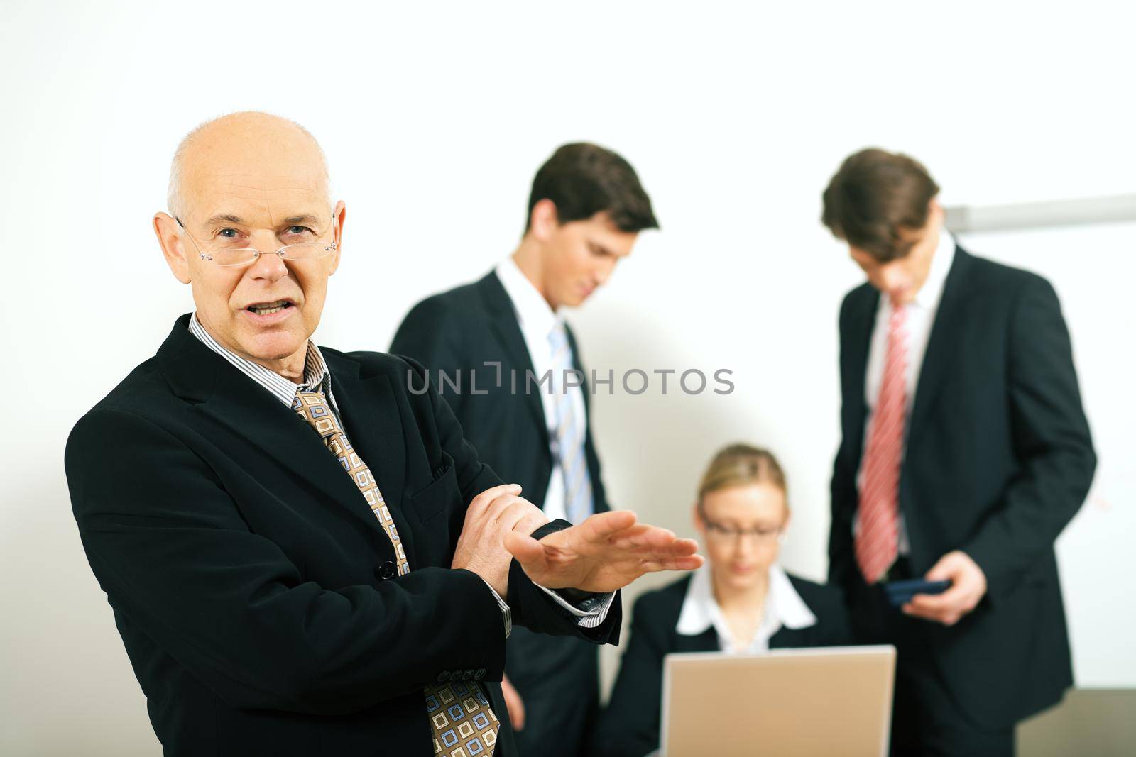 business team with a portrait of the team leader in foreground (selective focus only on the team leader!)