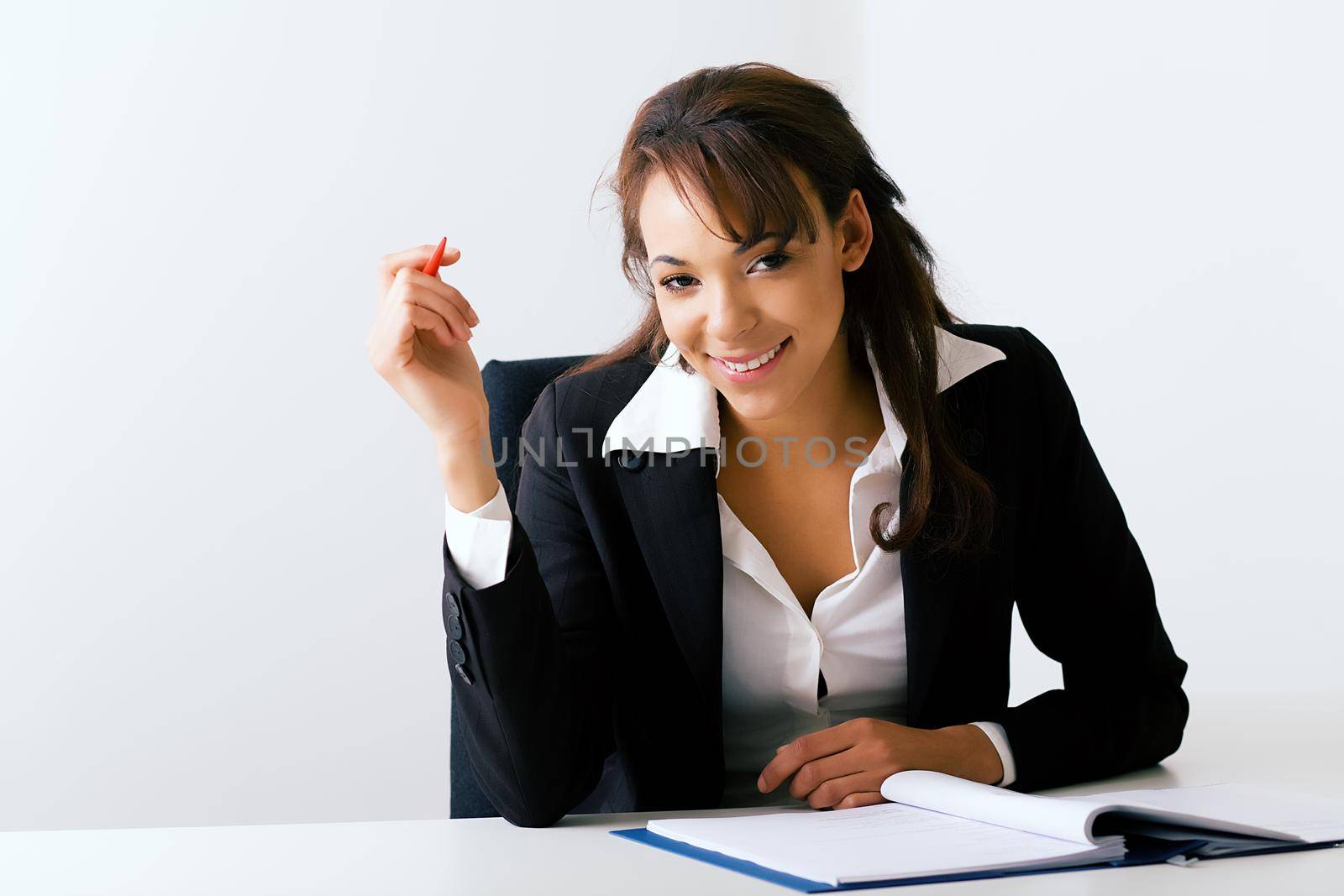 Business girl at desk by Kzenon