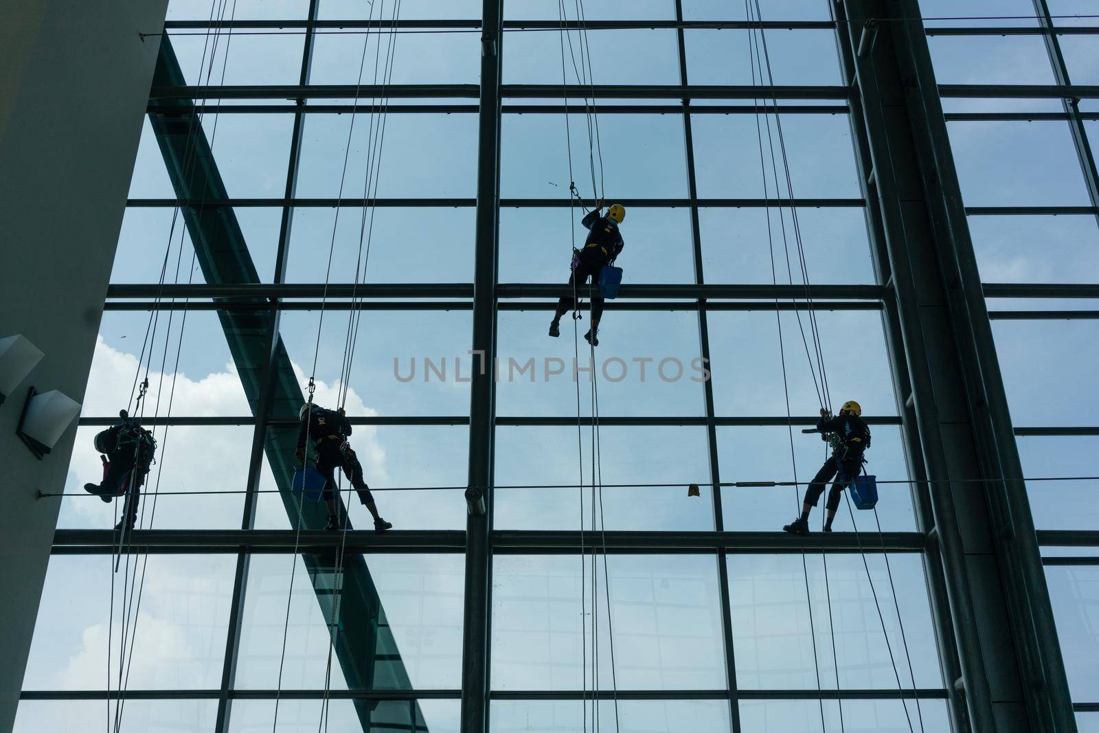 Professional window cleaners climbing up facade by Kzenon