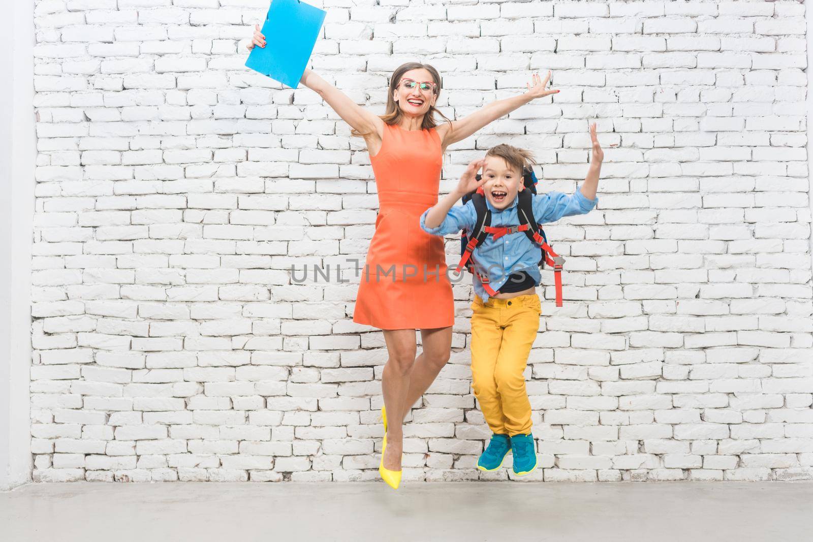 Student or pupil and teacher being excited about school jumping high