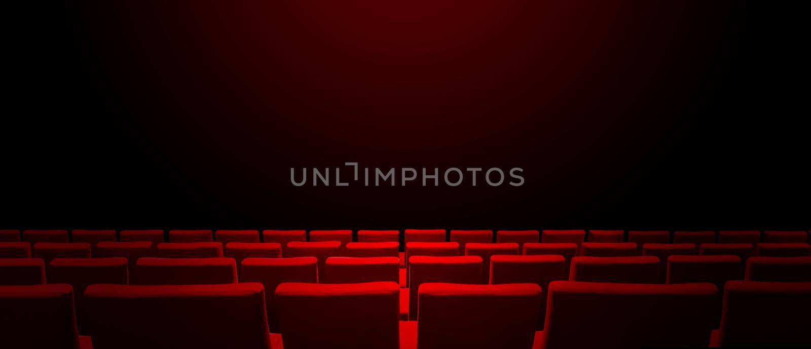 Cinema movie theatre with red seats rows and a black copy space background. Horizontal banner