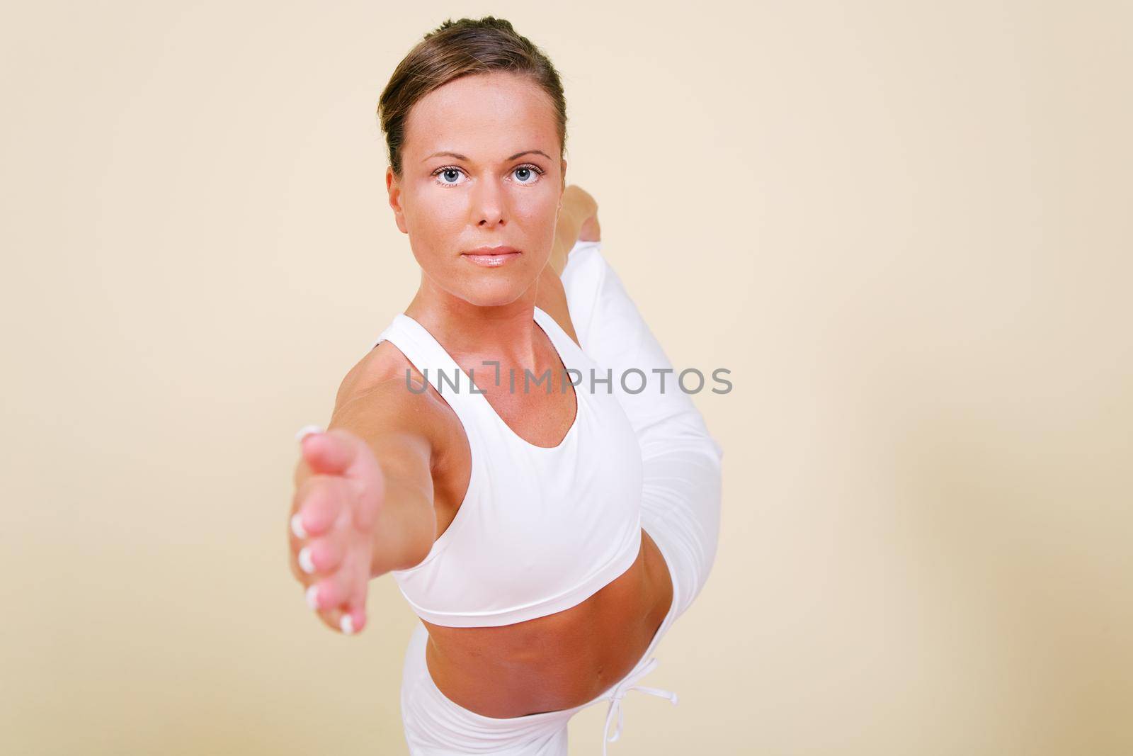 Young woman in a yoga position (Nata Rajasana)