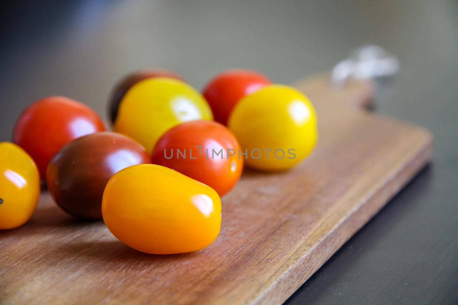 Cocktail tomatoes on a cutting board by daboost