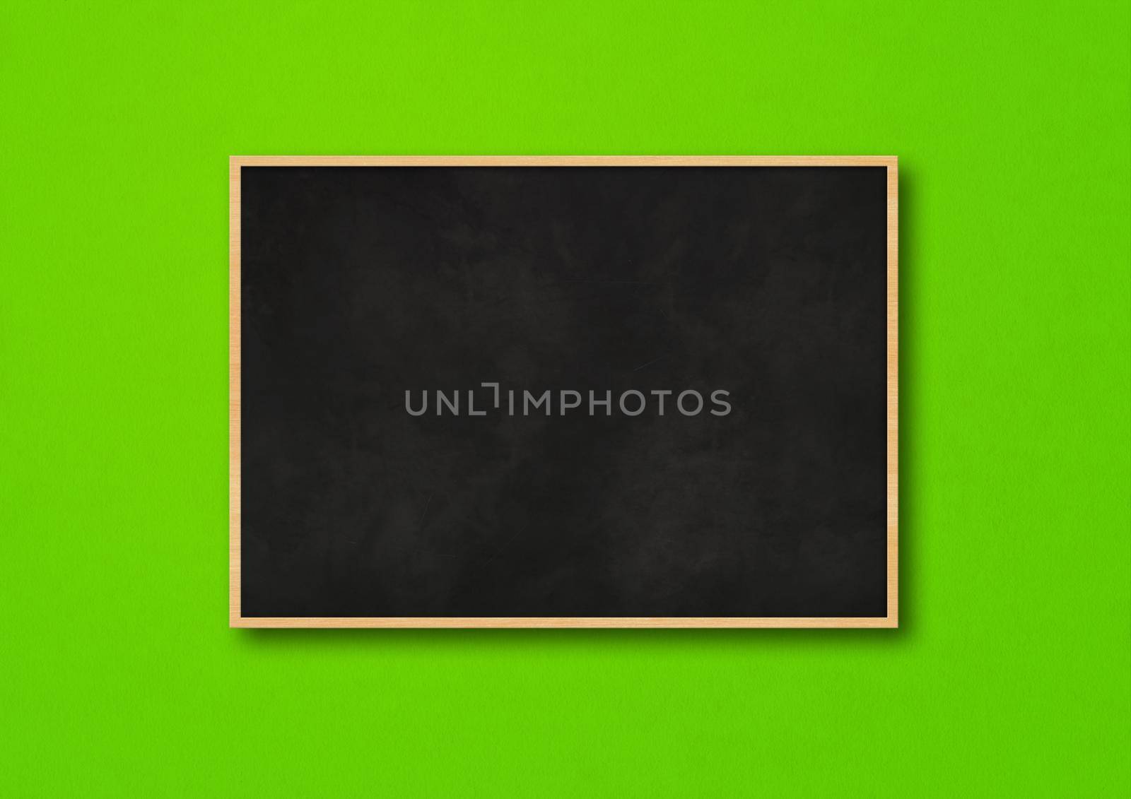 Traditional black board isolated on a green background by daboost