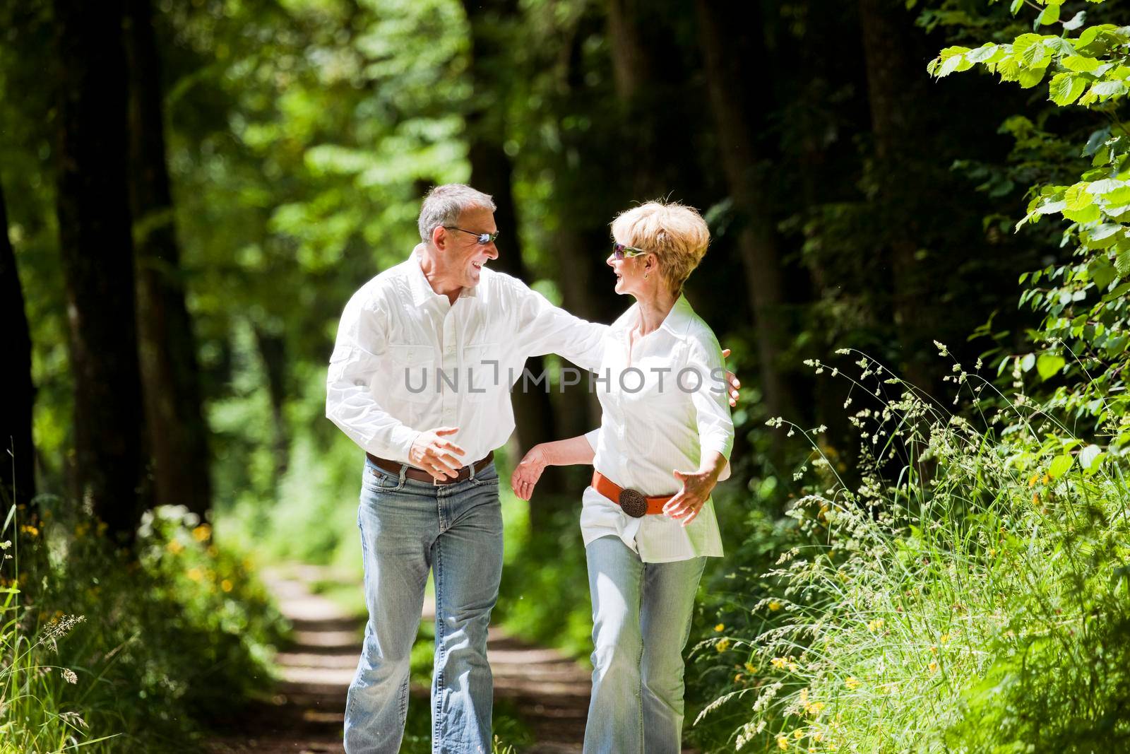 Happy mature couple outdoors by Kzenon