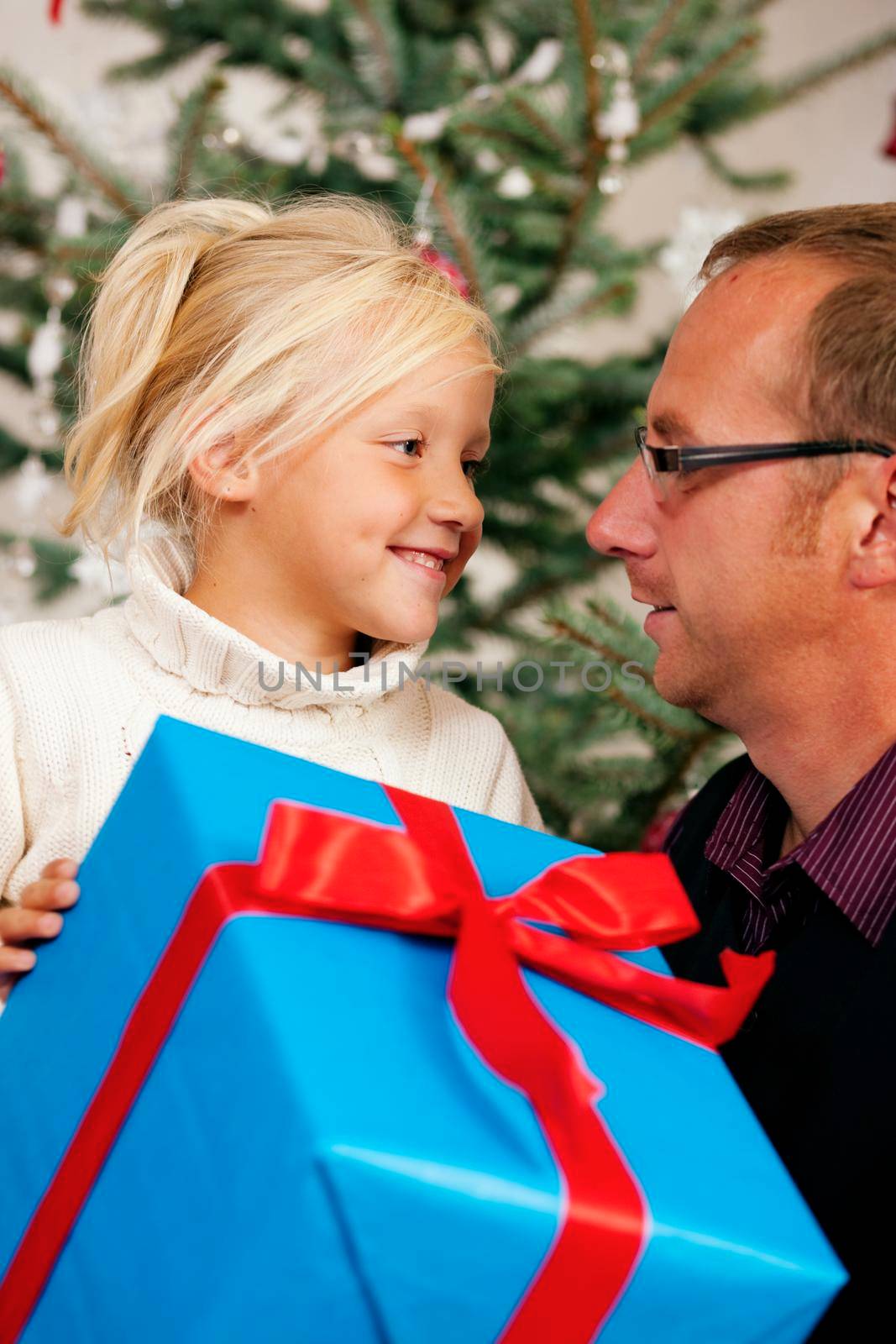 Young girl receives a gift by her father