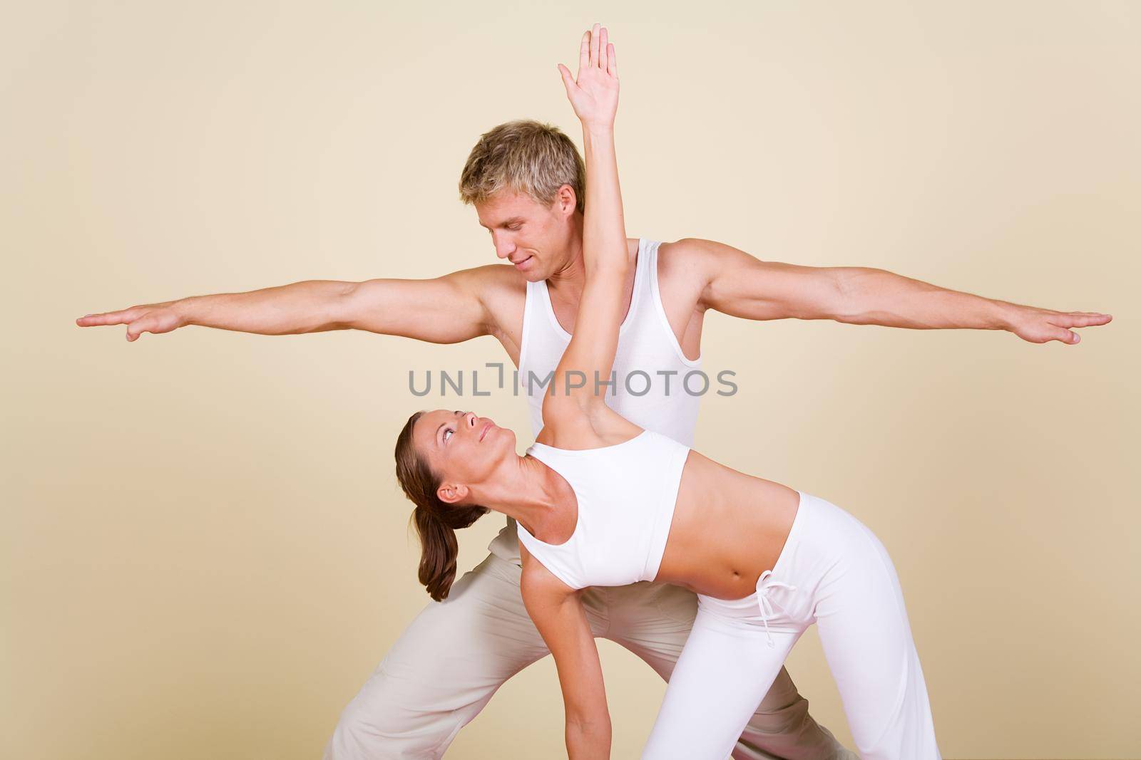 Couple (male / female) doing yoga exercises together