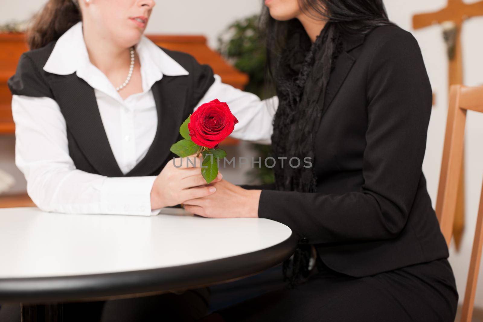 Undertaker is advising a client for the funeral and is giving her solace