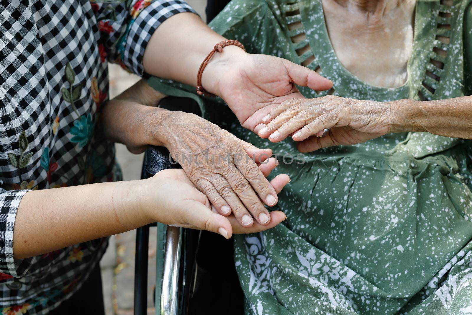 Elderly asian woman on wheelchair at home with daughter take care