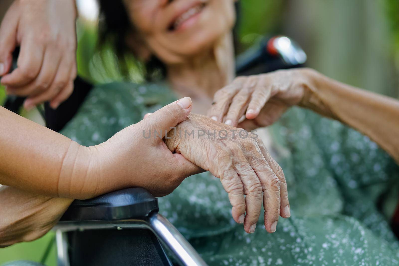 Elderly asian woman on wheelchair at home with daughter take care