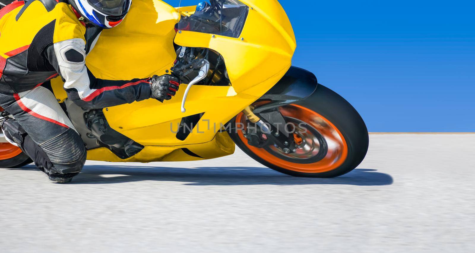 Motorcycle leaning into a fast corner on race track by toa55