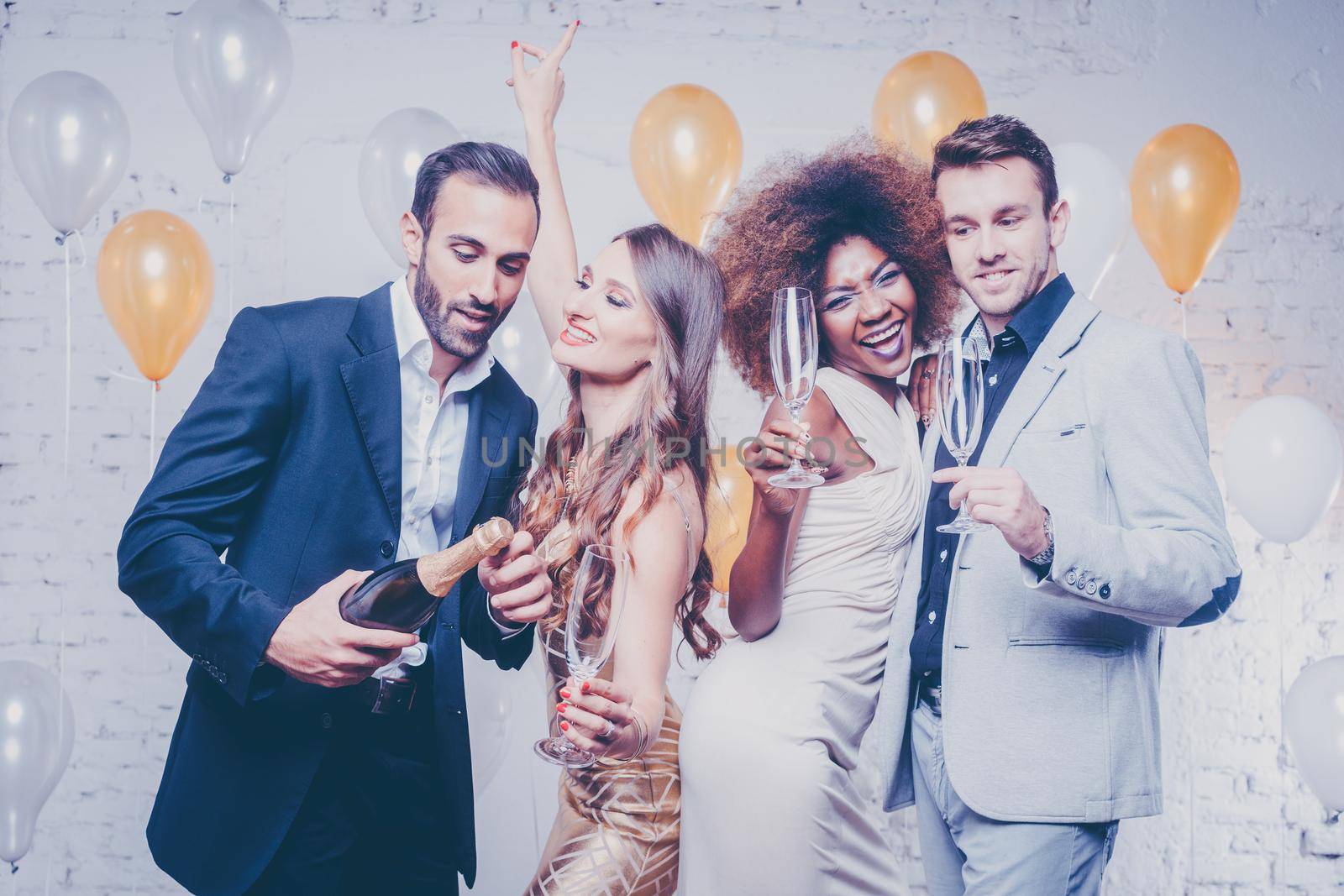 Group of women and men celebrating new years eve or a birthday with champagne