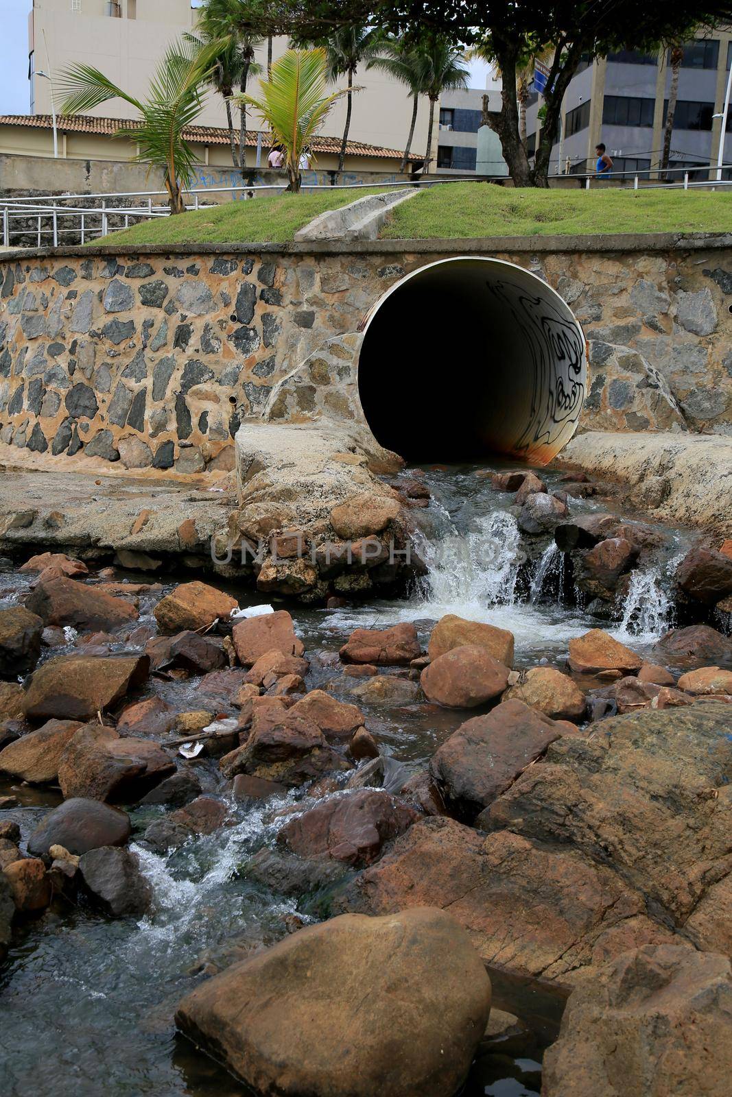 salvador, bahia, brazil - january 15, 2021: pipe is seen pouring rainwater and sewage on Ondina beach in the city of Salvador.