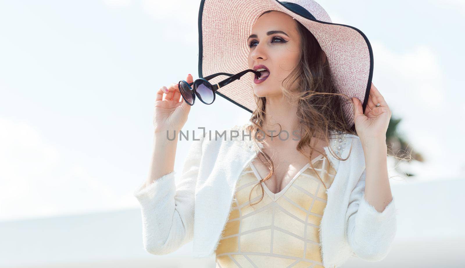 Woman with sunglasses and sun hat by Kzenon