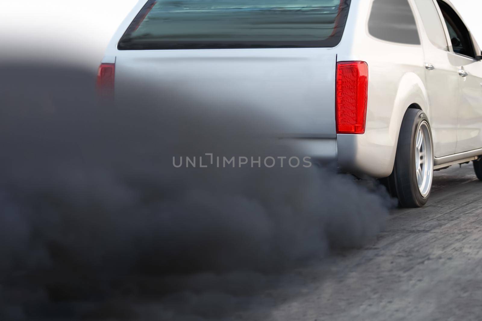 air pollution crisis in city from diesel vehicle exhaust pipe on road by toa55