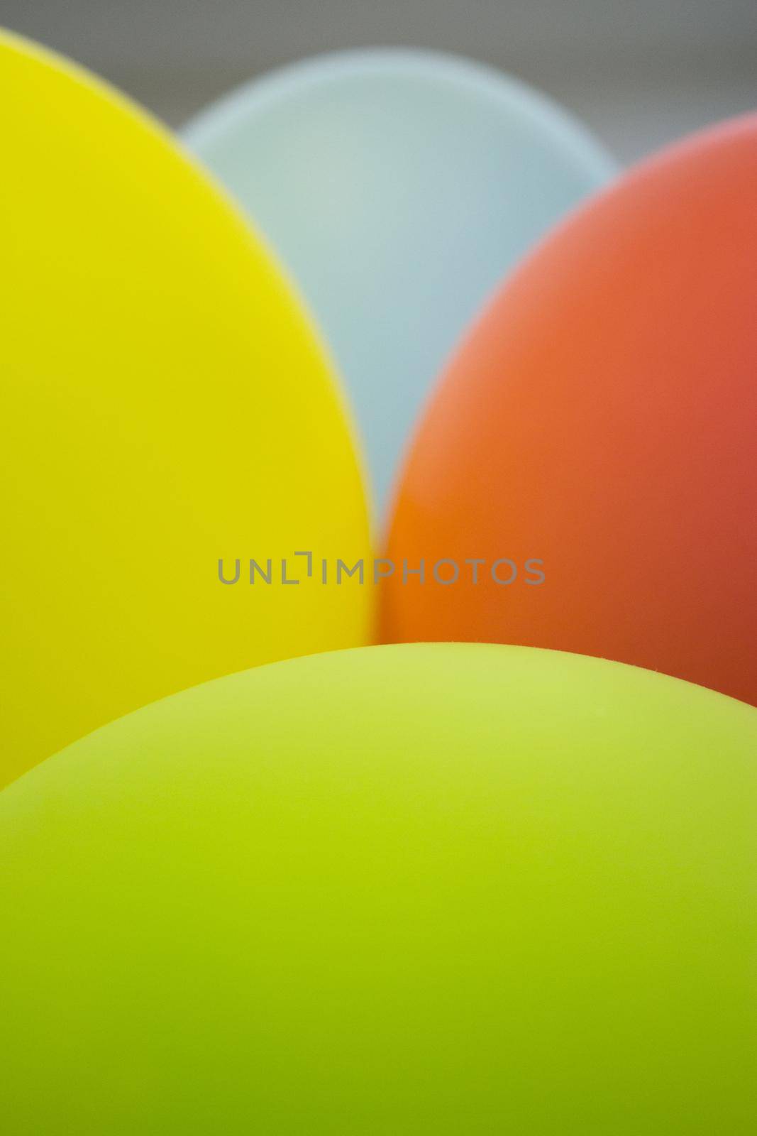 Balloons of colors grouped, green, pink, yellow, orange, pink. No people
