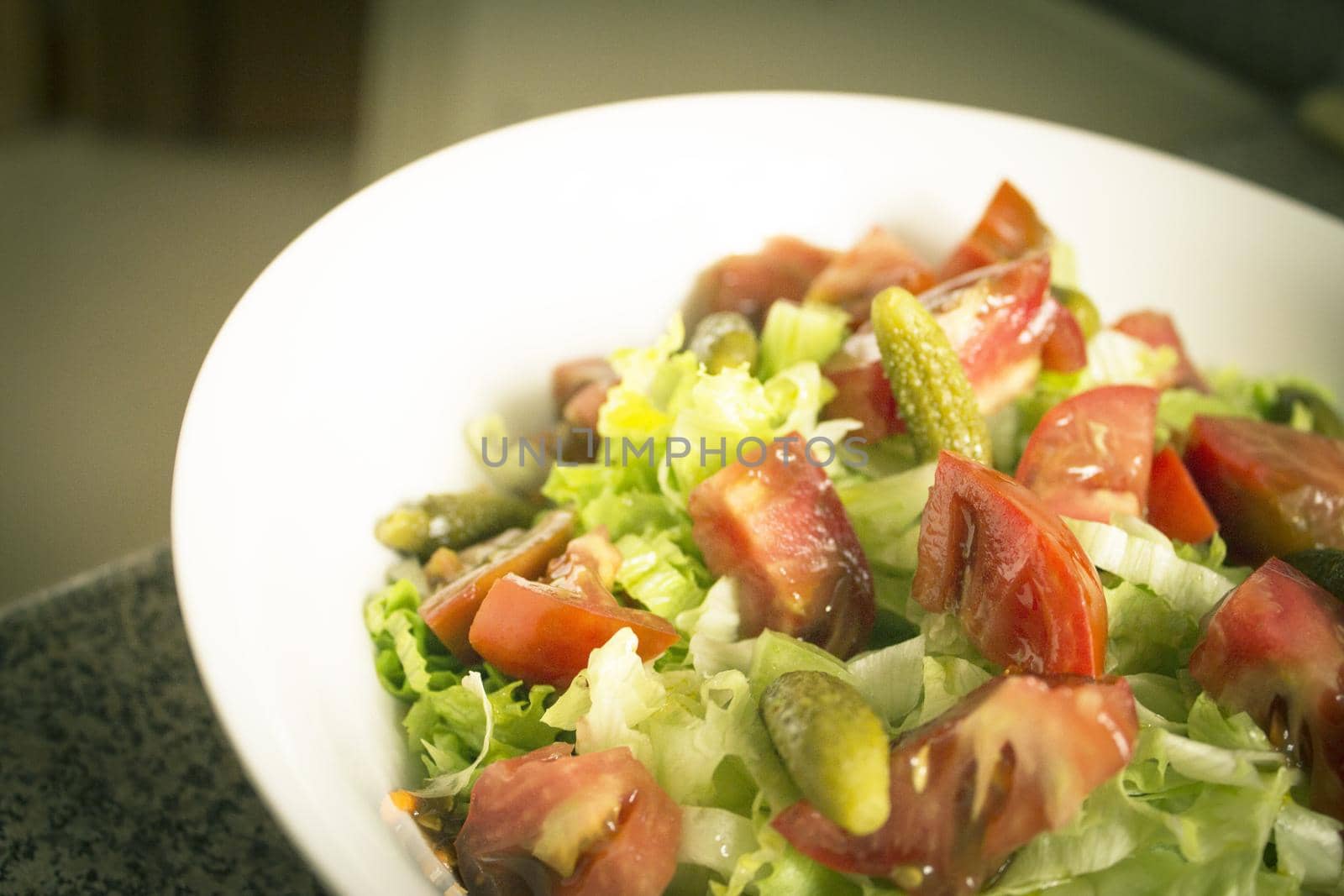 Lettuce salad with tomato and pickles. Raw food