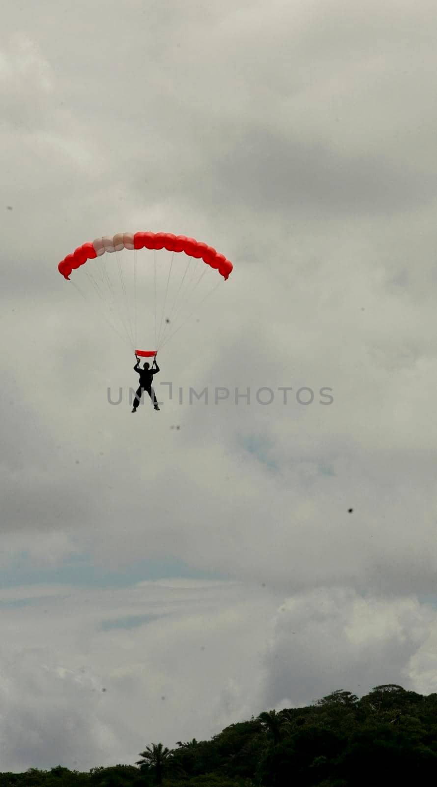 itaparica, bahia / brazil - august 18, 2012: person is seen during a parachute jump on the island of Itaparica.
