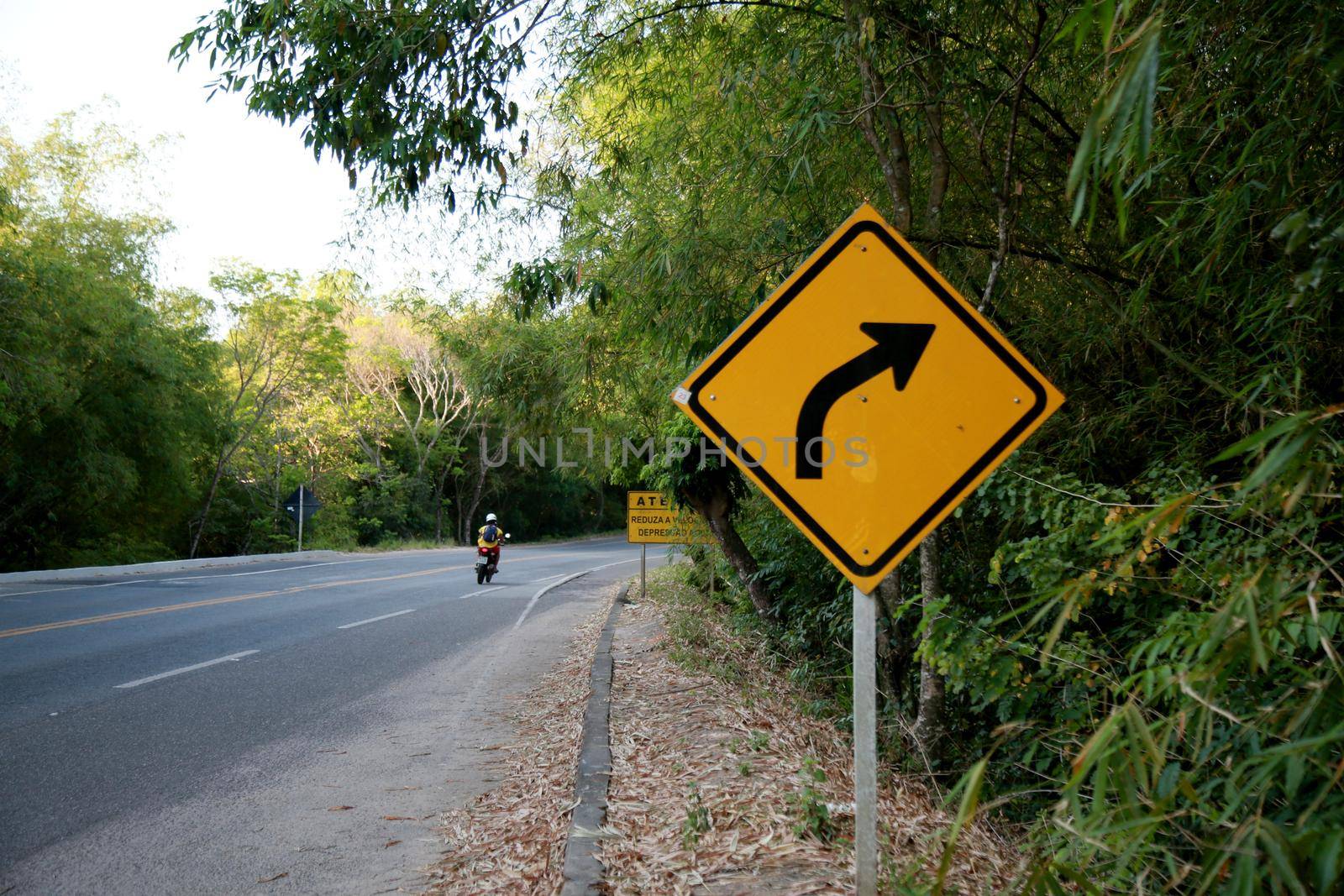 mata de sao joao, bahia / brazil - october 16, 2020: traffic signs indicate a sharp right turn on highway BA 099, in the municipality of Mata de Sao Joao.