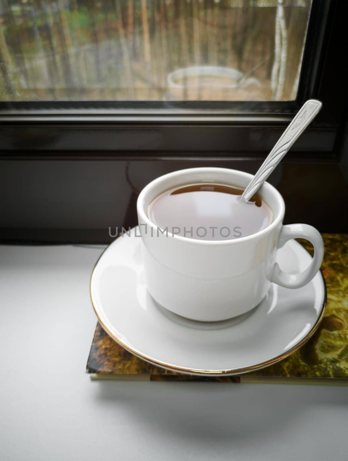 A Cup of tea and a book on the windowsill by georgina198