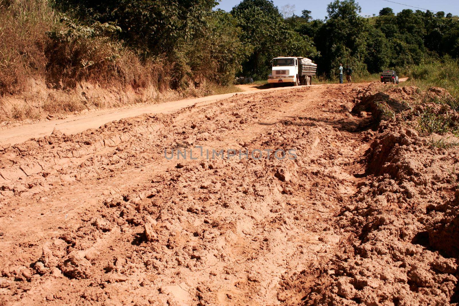 jucurucu, bahia / brazil - april 30, 2010: vehicle travels on a bumpy dirt road that connects the cities of Itamaraju to Jucurucu in southern Bahia.