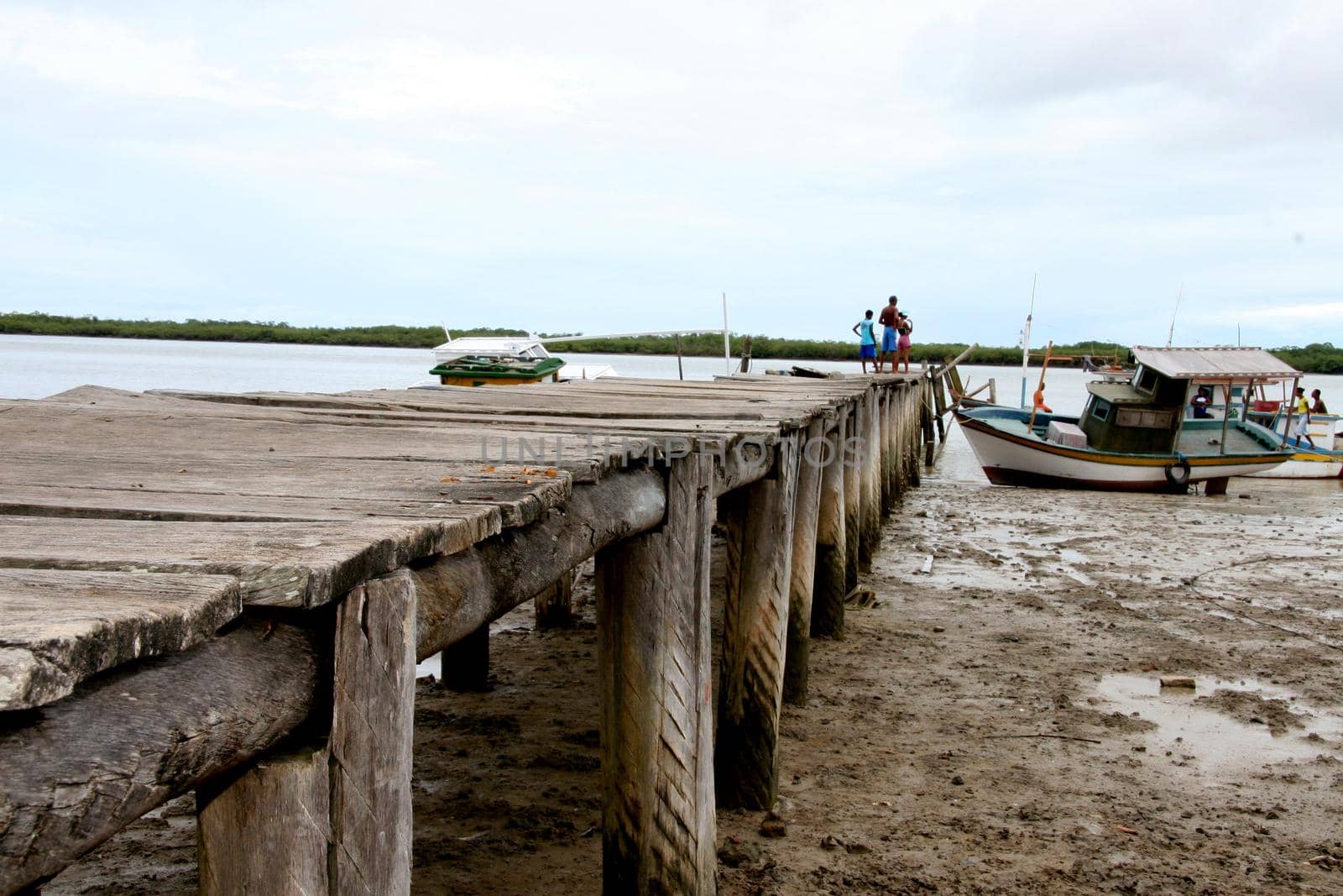 caravelas, bahia / brazil - january 25, 2008:  wooden pier to access the port of fishing boats on the Caravelas River in the city of Caravelas, in the south of Bahia.
