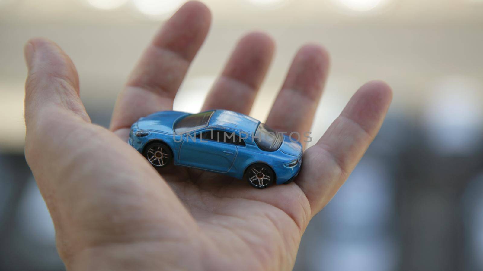 salvador, bahia brazil - may 26, 2020: hand holds replica of a miniature car.


