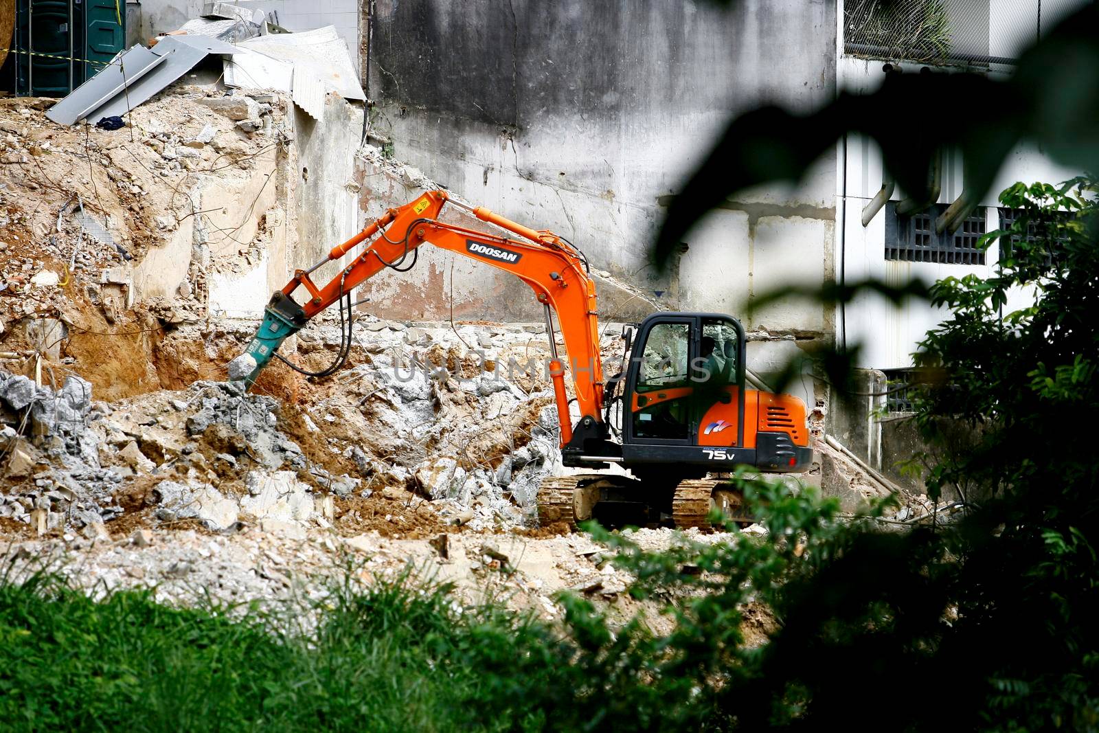 salvador, bahia / brazil - august 26, 2014: Machine is seen in the demolition of a clinic on Manoel Barreto street in Graça neighborhood, in the city of Salvador.