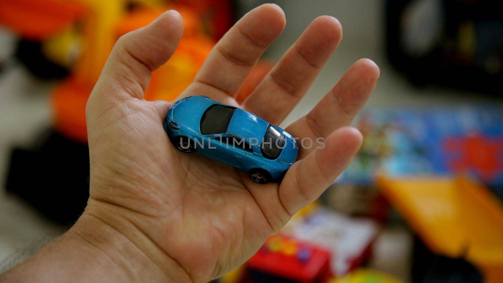 salvador, bahia brazil - may 26, 2020: hand holds replica of a miniature car.


