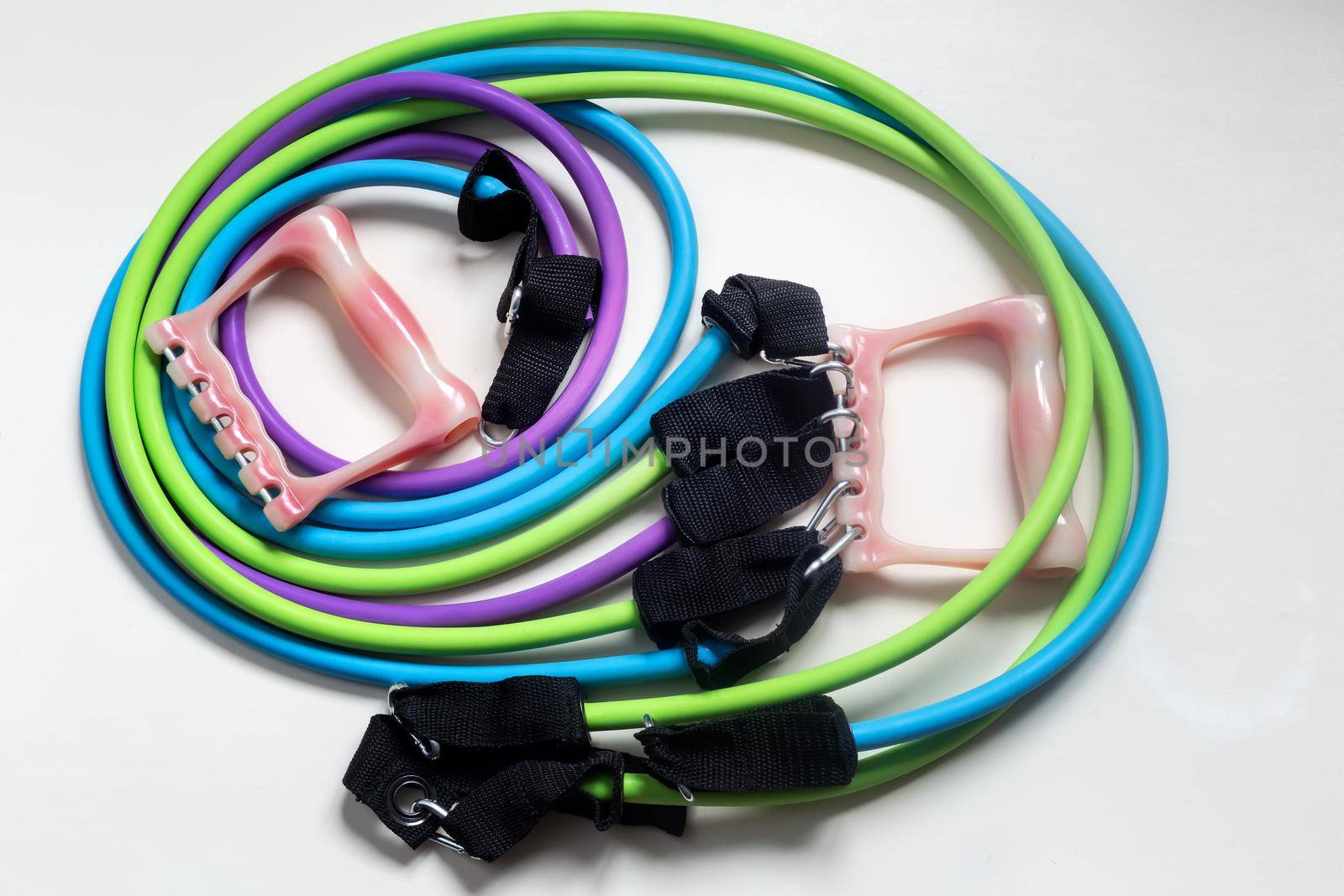 Sports expander with a set of elastic bands and handles to strengthen the muscles of various groups, multifunctional. It can be used for training at home, which is useful during restrictions due to the epidemic of coronavirus infection.