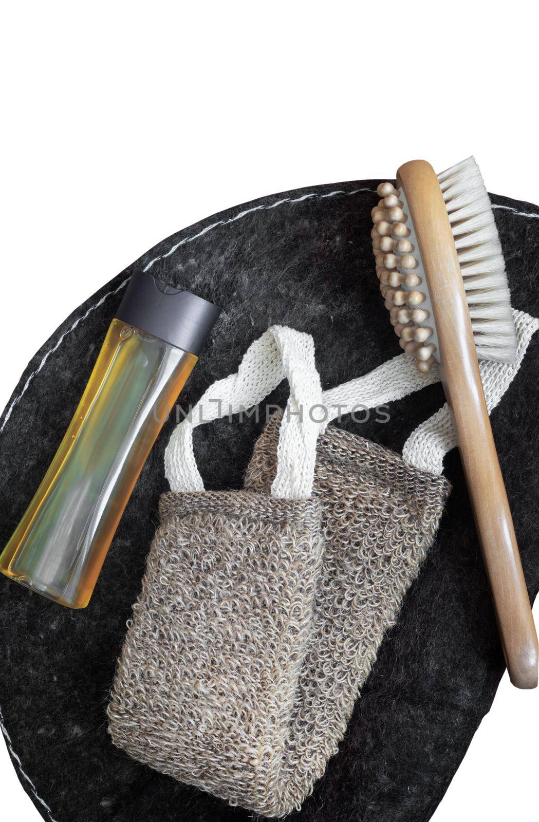 Accessories for visiting the bath or sauna: a washcloth, a mat, a massage brush and shower gel. Top view with copy space. Flat lay. Isolated on a white background