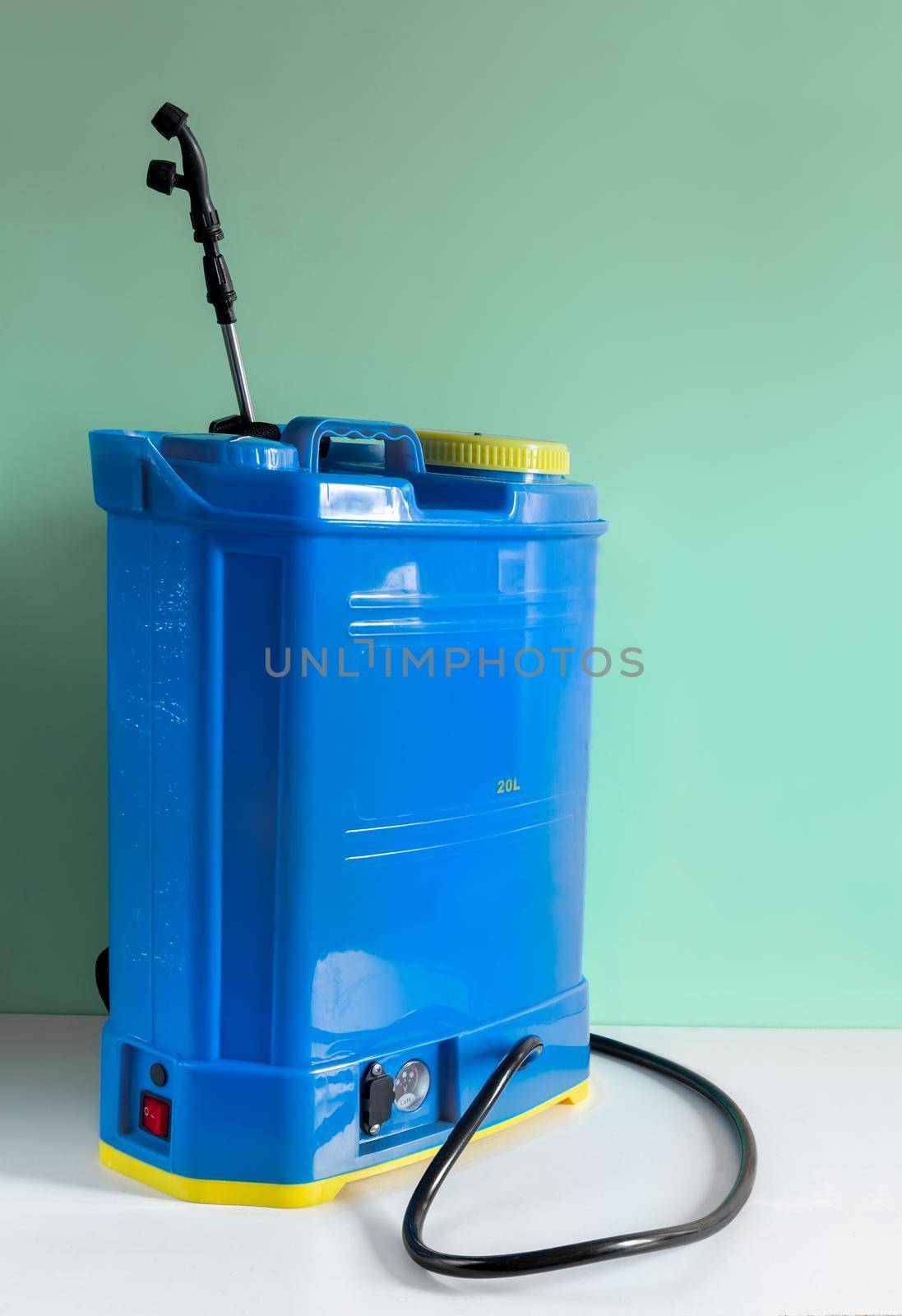 Backpack battery sprayer for protecting trees and plants from diseases and pests. The pressure is increased using a battery-powered pump. Close-up, copy space