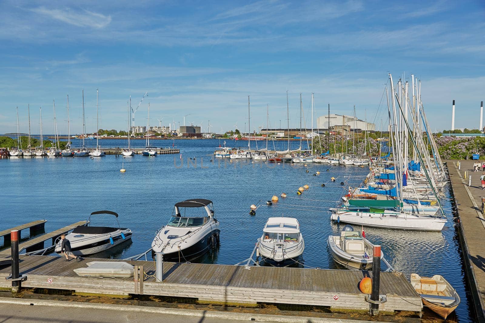 COPENHAGEN, DENMARK - MAY 25, 2017: Luxury speedboats docked along side of wooden promenade at Danish capital of Copenhagen.