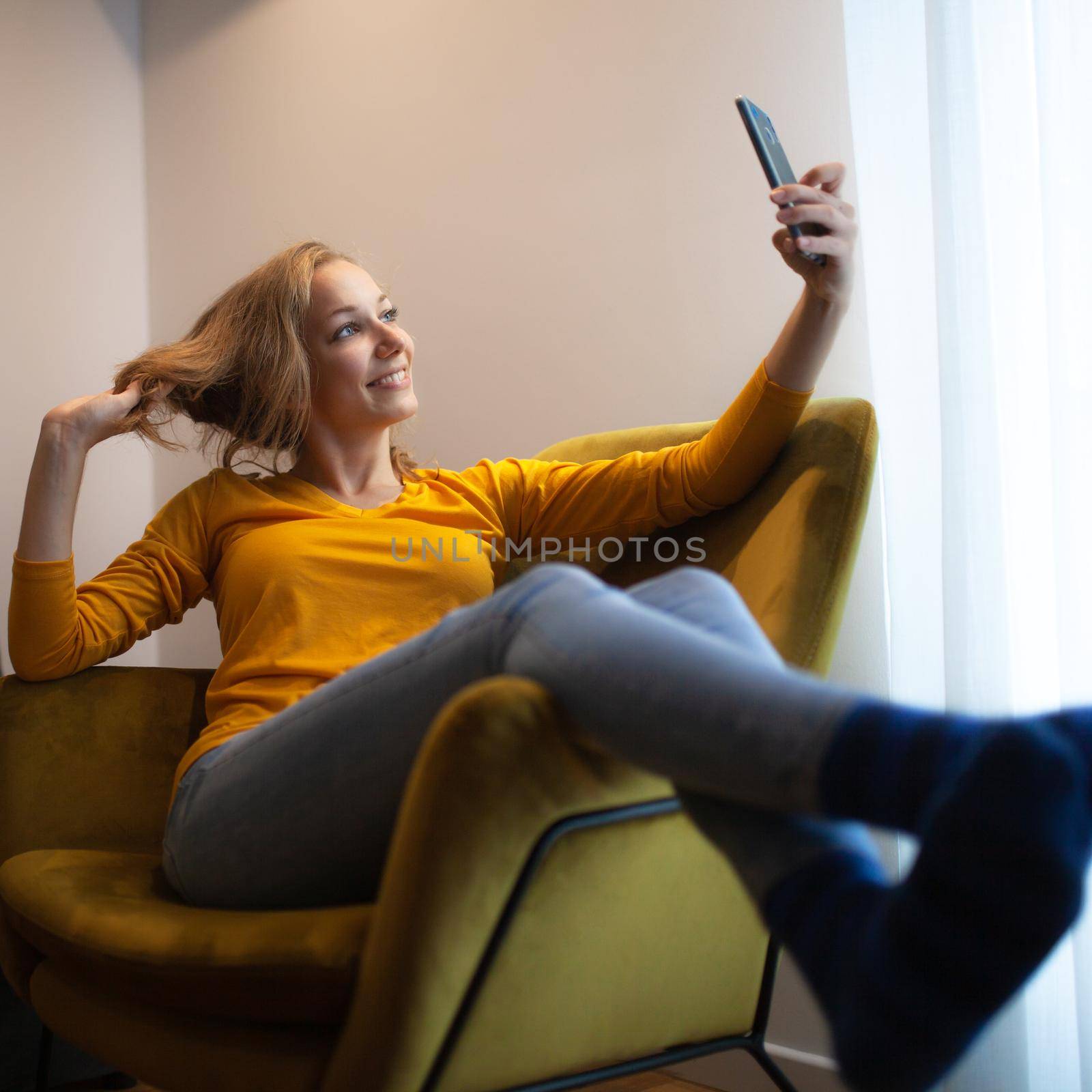 girl at home taking selfie on her smart phone