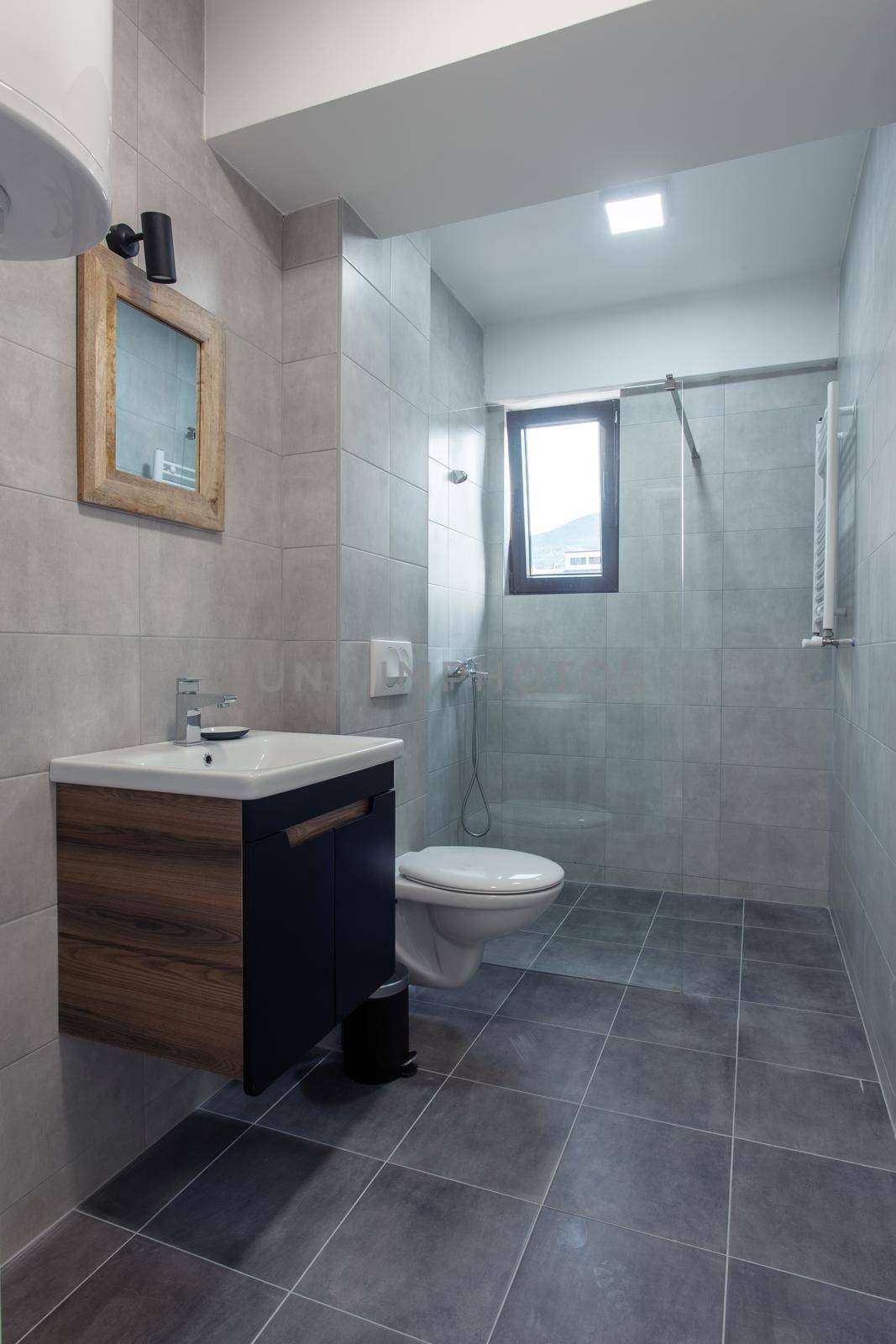 modern toilet interior with glass shower