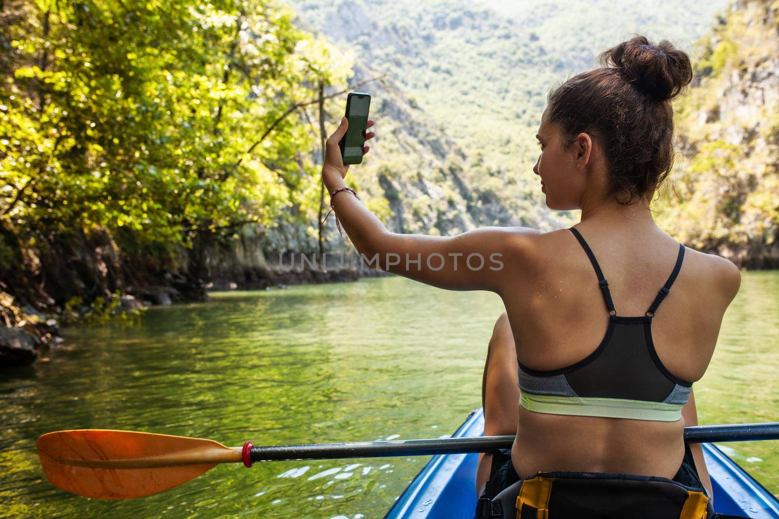 girl taking selfie on a kayak ride by kokimk