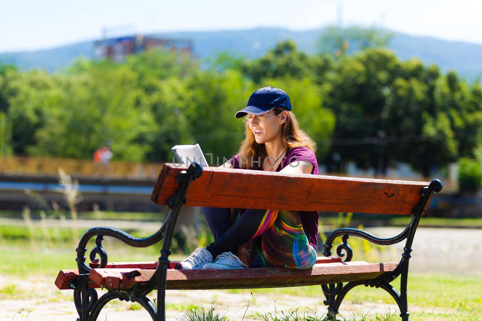 girl on a bench reading a book by kokimk