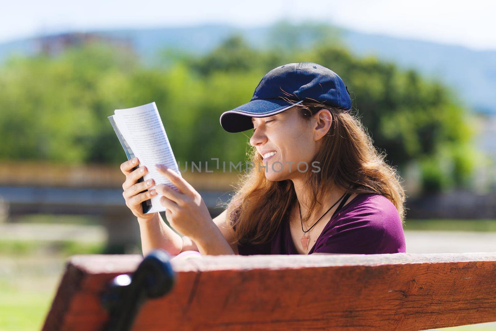 girl on a bench reading a book by kokimk