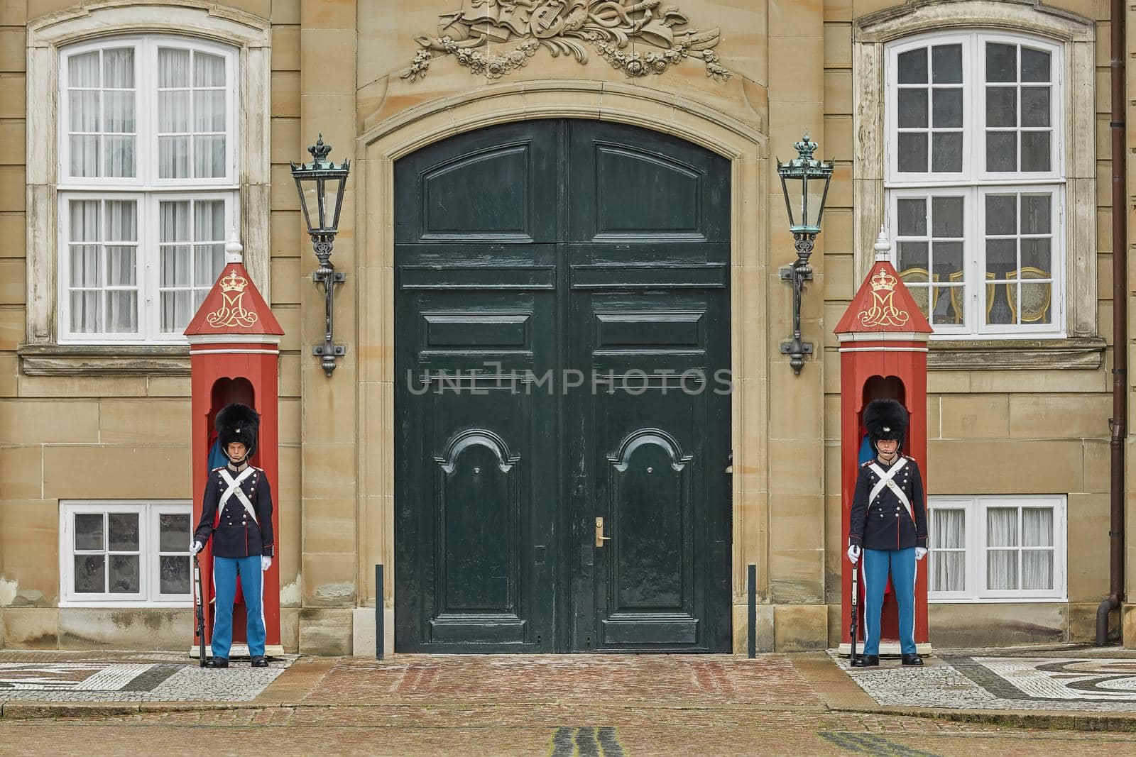 Military officers standing guard outside the Amalienborg Palace in Copenhagen, Denmark by wondry